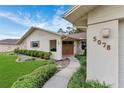 Inviting front entrance with double doors, decorative stone accents, and well-maintained landscaping at 5078 Florentine Ct, Spring Hill, FL 34608