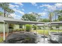 View of the carport, providing covered parking spaces in front of the single-story residences at 5084 Barrington Cir # 3202, Sarasota, FL 34234