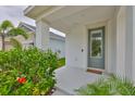 Welcoming front entrance with stylish door, columns and colorful landscaping at 5511 Del Coronado Dr, Apollo Beach, FL 33572
