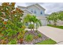 Inviting two-story home with lush landscaping and a pristine driveway at 5511 Del Coronado Dr, Apollo Beach, FL 33572