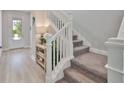 Elegant staircase with carpeted steps and white railing, bright natural light at 5511 Del Coronado Dr, Apollo Beach, FL 33572