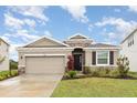 Charming single-story home with a two-car garage, stone accents, and well-maintained landscaping at 5620 Night Owl Ter, Palmetto, FL 34221