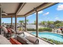 Relaxing screened lanai with a pool overlooking the serene waterfront at 5782 Westshore Dr, New Port Richey, FL 34652