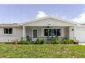 Inviting home exterior with a covered porch, a ceiling fan, and well-maintained landscaping at 5840 Liddell Dr, New Port Richey, FL 34652