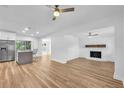 Spacious living area featuring new floors, modern lighting, and a fireplace with a stone accent wall at 5927 10Th N St, St Petersburg, FL 33703