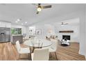 Spacious living room with modern furnishings and a fireplace, seamlessly flowing into the kitchen at 5927 10Th N St, St Petersburg, FL 33703