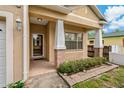 Inviting front porch featuring classic columns and brick accents, perfect for enjoying the outdoors at 6625 Interbay Blvd, Tampa, FL 33611