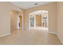 Open-concept living room with tile floors, archways, and ample natural light, ideal for entertaining guests at 6625 Interbay Blvd, Tampa, FL 33611