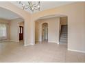 Spacious living room featuring tile floors, archways, and a staircase leading to the upper level at 6625 Interbay Blvd, Tampa, FL 33611