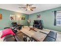 Cozy living room featuring a ceiling fan, decorative art, and comfortable seating at 7414 Indigo Oasis Ct, Gibsonton, FL 33534