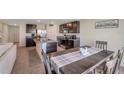 Eat-in kitchen features stainless steel appliances, granite countertops, and dark wood cabinetry at 7641 Sail Clover Ln, Zephyrhills, FL 33540
