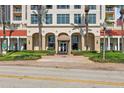 Elegant building exterior showcases a grand entrance with palm trees and manicured landscaping at 100 Beach Ne Dr # 301, St Petersburg, FL 33701