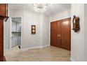 Inviting foyer with gleaming wood floors, chandelier, and elegant double doors sets a sophisticated tone at 100 Beach Ne Dr # 301, St Petersburg, FL 33701