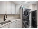 Well-organized laundry room features modern washer and dryer, sink, and ample storage space at 100 Beach Ne Dr # 301, St Petersburg, FL 33701