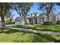 Beautiful single Gathering home boasts a manicured lawn, mature trees, and a three car garage at 10244 Shadow Branch Dr, Tampa, FL 33647