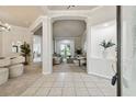 Elegant foyer features neutral tile floors, arched doorways, and a view into the living room at 10244 Shadow Branch Dr, Tampa, FL 33647