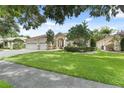 Beautiful home with a well-manicured lawn, three-car garage, stone accents, and charming curb appeal at 10310 Carroll Cove Pl, Tampa, FL 33612