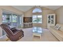 Comfortable living room with a ceiling fan, neutral walls, and sliding doors leading to patio at 1111 Golfview Woods Dr # 1111, Sun City Center, FL 33573