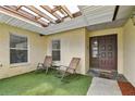 Cozy covered patio with rocking chairs leading to the front door at 12306 91St Ter, Seminole, FL 33772