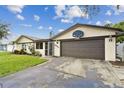 Attractive home exterior featuring a basketball hoop above the two-car garage at 12306 91St Ter, Seminole, FL 33772