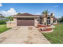 Charming home boasts a two-car garage, mature landscaping, and a welcoming front entrance at 13386 Lawrence St, Spring Hill, FL 34609