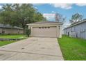 Charming single-story home with a spacious driveway, two-car garage, and manicured lawn at 1502 Marsh Wood Dr, Seffner, FL 33584