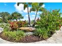 Artistic yard landscaping showcasing beautiful flowers and plants, including a rock feature at 15415 Mulholland Rd, Parrish, FL 34219