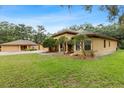 Charming home with mature landscaping and a well-manicured lawn creating a welcoming curb appeal at 16608 Livingston Ave, Lutz, FL 33559