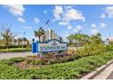 Southshore Bay community sign surrounded by lush greenery and colorful flowers at 17005 Avon Dive Ln, Wimauma, FL 33598