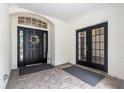 Welcoming front porch with decorative wreath, double doors and brick flooring at 17910 Timber View St, Tampa, FL 33647