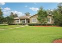Charming single story home with stone details, beautiful landscaping, and a well-maintained lawn at 1803 143Rd E Ct, Bradenton, FL 34212