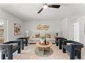 Well-lit living room featuring modern furniture, neutral decor, and hardwood floors, creating a serene and stylish atmosphere at 1909 Dover Ct, Oldsmar, FL 34677