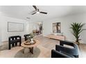 Open-concept living room with contemporary furnishings, neutral color palette, and hardwood floors, seamlessly connected to the dining area at 1909 Dover Ct, Oldsmar, FL 34677