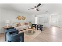 Bright living room with modern decor, contemporary furniture, neutral paint, and light hardwood floors, creating a stylish and inviting space at 1909 Dover Ct, Oldsmar, FL 34677