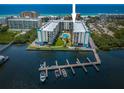 Waterfront condo buildings with a pool, boat docks, and water views at 19531 Gulf Blvd # 306, Indian Shores, FL 33785