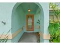 Inviting front door entrance featuring an arched alcove, unique textured walls, and decorative pendant light at 2418 Deltona Blvd, Spring Hill, FL 34606