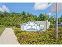 Community entrance sign with landscaping and a street sign visible at 2822 Jacob Crossing Ln, Holiday, FL 34691