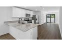 Modern kitchen featuring stainless steel appliances, granite countertops, and seamless access to the living area at 29595 Fedora Cir, Brooksville, FL 34602