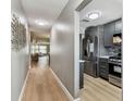 Bright hallway showcasing modern kitchen with stainless steel appliances at 2960 59Th S St # 303, Gulfport, FL 33707
