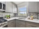 Updated kitchen with gray cabinets, stainless steel appliances, and bright countertops at 2960 59Th S St # 303, Gulfport, FL 33707