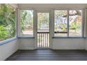 Enclosed porch with wood flooring and views of the surrounding neighborhood at 317 19Th S Ave, St Petersburg, FL 33705