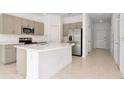 Modern kitchen with stainless steel appliances and a large island at 34234 Polacca Ln, Wesley Chapel, FL 33543