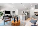 Modern living room showcases an open-concept layout with neutral tones, stylish furniture and stainless steel appliances at 34234 Polacca Ln, Wesley Chapel, FL 33543