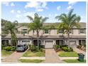 Inviting townhouse featuring well-maintained landscaping, a one-car garage and brick paved driveways at 3901 Silverlake Way, Wesley Chapel, FL 33544