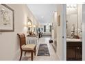 Inviting hallway with tile flooring leads to a cozy living room with natural light and access to the half bath at 3901 Silverlake Way, Wesley Chapel, FL 33544