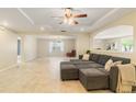 Spacious living room featuring tile floors, an open layout, recessed lighting, and a ceiling fan at 39721 Meadowood Loop, Zephyrhills, FL 33542