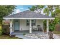Inviting home showcasing a quaint front porch, comfortable seating, and meticulous landscaping at 4339 58 N Ave, St Petersburg, FL 33714