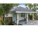 Charming bungalow featuring a welcoming front porch with rocking chairs and a well-maintained yard at 4339 58 N Ave, St Petersburg, FL 33714