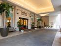 Exterior of the building entrance with a covered walkway and tropical landscaping at 450 Knights Run Ave # 1003, Tampa, FL 33602