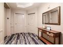 Hallway showing apartment door with console table and mirror at 450 Knights Run Ave # 1003, Tampa, FL 33602
